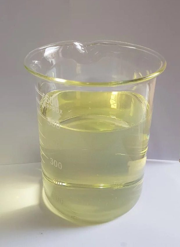 Beaker holding a pale yellow distillate sample drawn at loading.